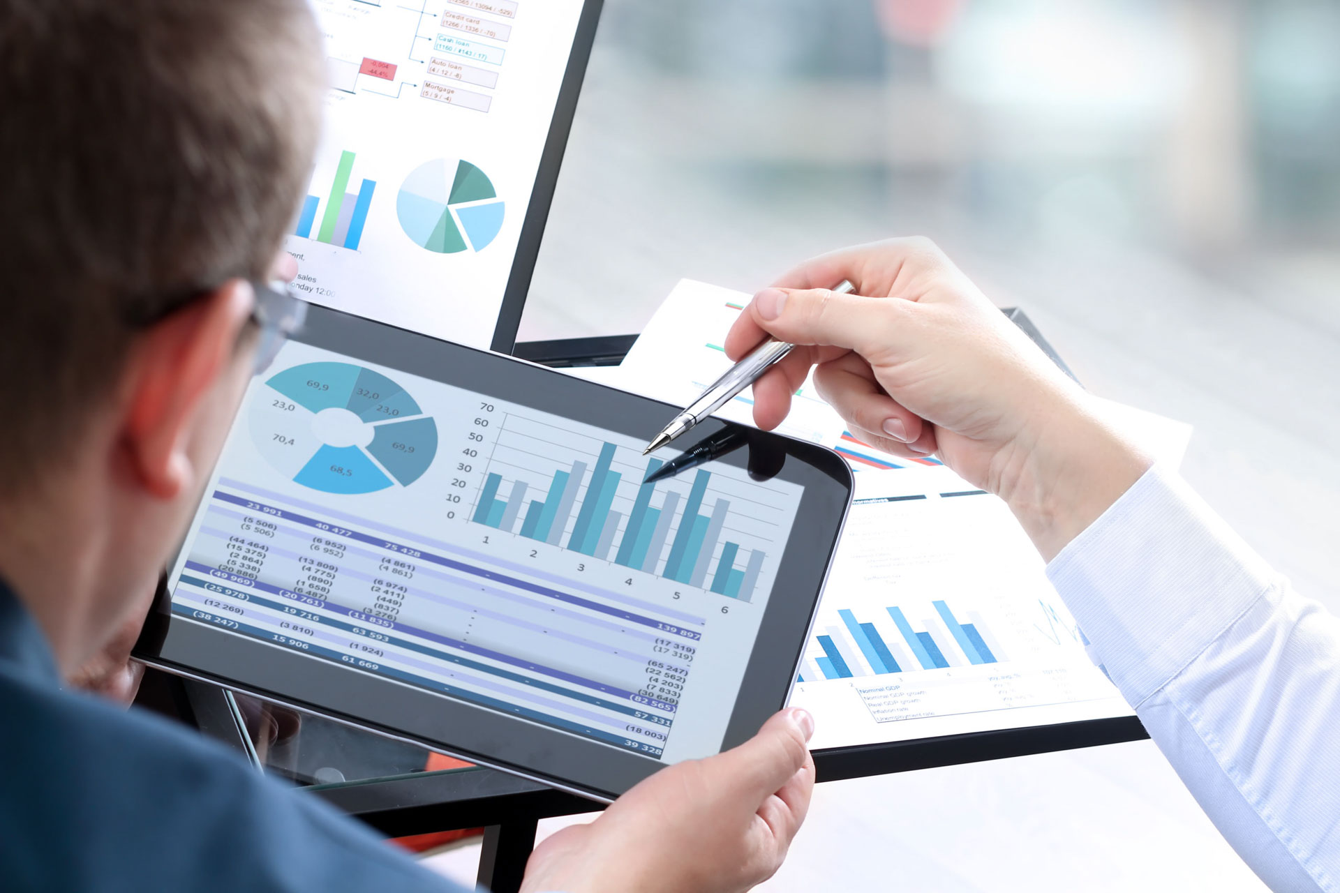 Man pointing to an ipad graph showing cashflow improvements